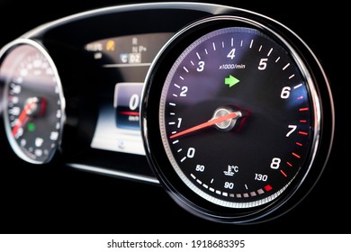 Close up shot of a tachometer in a car. Car dashboard. Dashboard details with indication lamps. Car instrument panel. Dashboard with speedometer, tachometer, odometer. Car inside