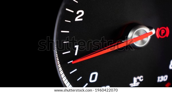 Close up shot of a\
tachometer in a car. Car dashboard. Dashboard details with\
indication lamps. Car instrument panel. Dashboard with tachometer,\
odometer. Car inside