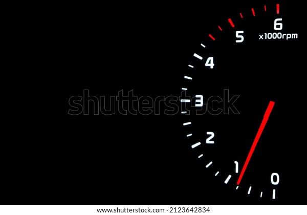 Close up shot of a\
tachometer in car. Car dashboard. Dashboard details with indication\
lamps.Car instrument panel. Dashboard with tachometer isolated on\
black