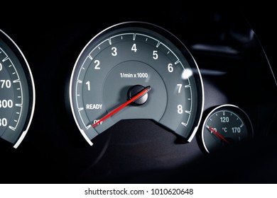 Close up shot of a tachometer, rounds of the engine per minute, in a car. 