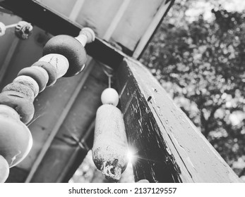 Close Up Shot Taken Of Rustic Wind Chimes Hanging From A Beach House Porch