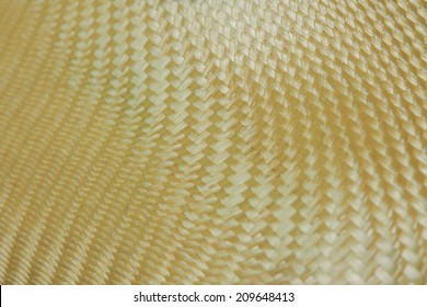 Close Up Shot Of Texture Of Golden Kevlar Fiber, The Material That Use As Astronaut Suit, Racing Car, Airplane And All Luxury Vehicles And Products