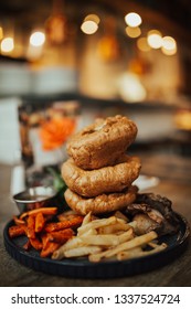 A Close Up Shot Of Traditional British Food, Sunday Roast. Yorkshire Pudding With Roasted Meat And Vegetables. Concept Of Family Lunch, Celebration And Traditional Cuisine.