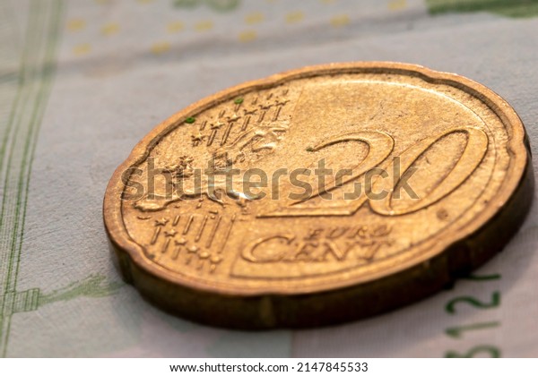 Close up shot of twenty euro cents with map of\
Europe on the coin face