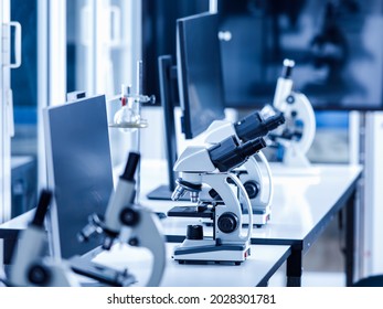 Close Up Shot Of Two Eyes Viewfinder Scientific Microscope In Row Of One Eye Microscopes Line In Blurred Foreground On Laboratory Working Table Using For Monitoring Coronavirus Covid 19 Virus Samples.