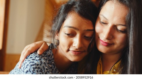 A Close Up Shot Of Two South Asian Girls Hugging And Smiling At Home In India