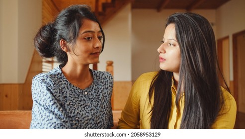 A Close Up Shot Of Two South Asian Girls Sitting And Talking To Each Other In India, Indoor