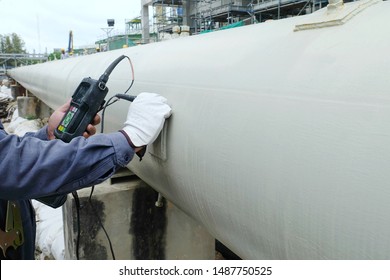 Close up shot of Ultrasonic thickness technician inspector looking at scale on monitor pipe line for using detector gage commencing inspection on wall thickness