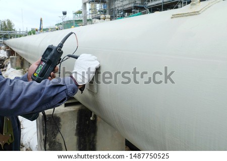 Close up shot of Ultrasonic thickness technician inspector looking at scale on monitor pipe line for using detector gage commencing inspection on wall thickness