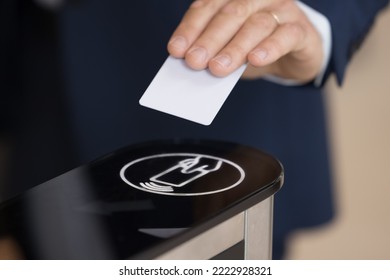 Close up shot unrecognizable authorized person, businessman in formal suit swipe pass card to electronic card reader passing security system checkpoint in modern office area before working day start - Powered by Shutterstock