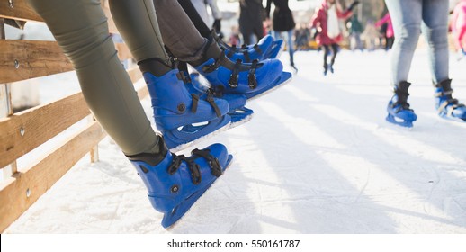 Close Up Shot Of Unrecognizable People Legs In Ice Skates. 