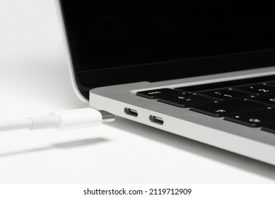 Close up shot of usb c cable plugging to a laptop computer.