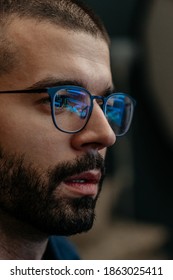 Close Up Shot Of Video Editor's Glasses With Reflection Of Working With Footage On His Personal Computer With Display Monitor Reflection. Video Editing Close Up View.