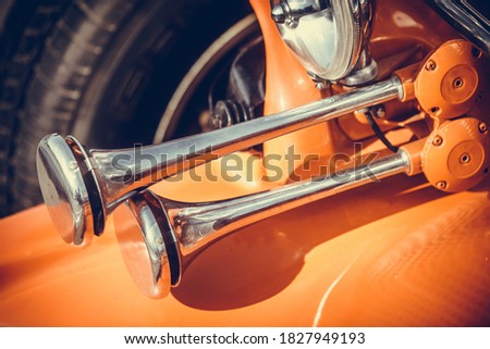 Close up shot of a vintage car double horn.
