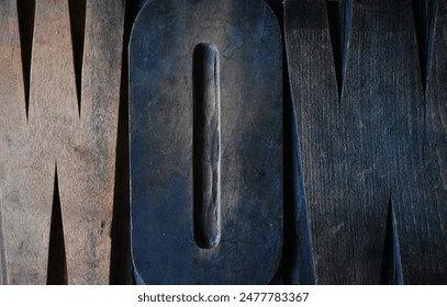 Close up shot of vintage letterpress wood type printing block, spelling the word WOW