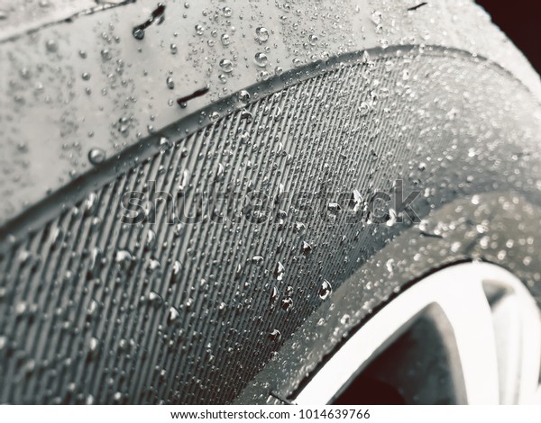 Close up shot of Wet Tire or Water drops on\
the tire background.