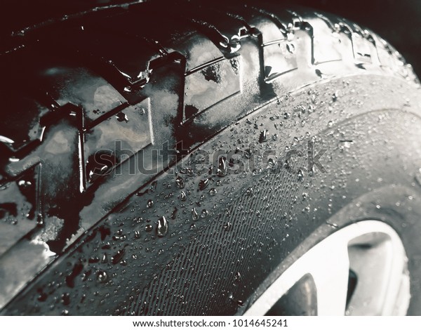 Close up\
shot of wet tire or Water Drop on the\
tire.