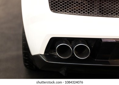 Close Up Shot Of White Car Dual Exhaust Pipe. Transportation Concept.