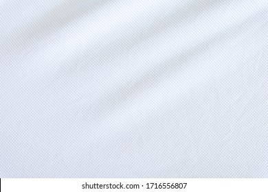 Close Up Shot Of White Fabric Cotton And Polyester Shirt. Casual Wear Over The Weekend Or Summer Time Season. Background Texture Concept With Copy Space For Text.