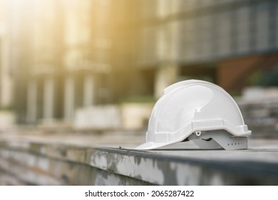 Close up shot White safety helmet hard hat put on the floor near modern building construction. Civil engineer concept. - Shutterstock ID 2065287422