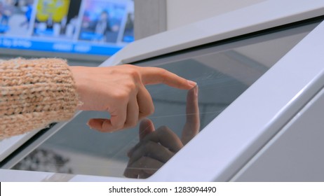Close up shot of woman hand using interactive touchscreen display at urban exhibition - scrolling and touching. Education and technology concept - Shutterstock ID 1283094490
