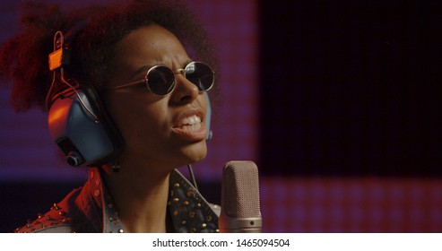 Close Up Shot Of Woman Singing In Recording Booth