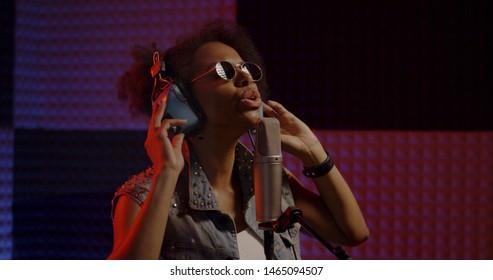 Close Up Shot Of Woman Singing In Recording Booth