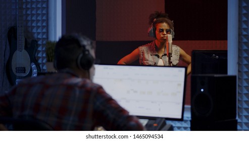 Close Up Shot Of Woman Singing In Recording Booth