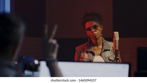 Close Up Shot Of Woman Singing In Recording Booth