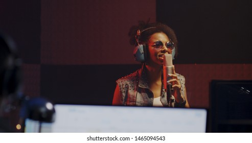 Close Up Shot Of Woman Singing In Recording Booth