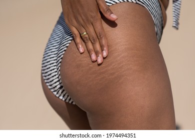 Close up shot of woman touching her stretch marks - Shutterstock ID 1974494351
