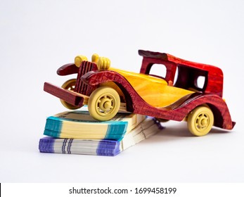 Close Up Shot Of A Wooden Vintage Car Toy On Money Notes Shot Ag