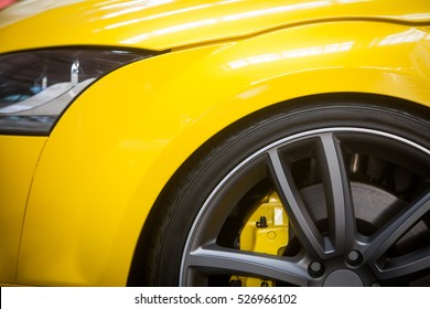 Close up shot of a yellow car rim.
