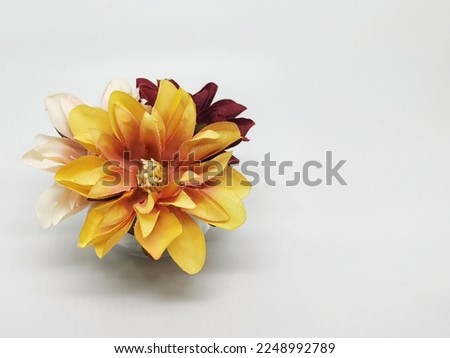 Close up shot of yelow orange ombre artificial flower with white background