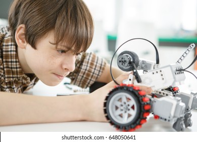 Close Up Shot Of A Young Boy Concentrating Repairing His Electronic Robot Toys Playing Building Creating Invention Electronics Robotics Technology Scientific Education Hobby Leisure Lifestyle Children