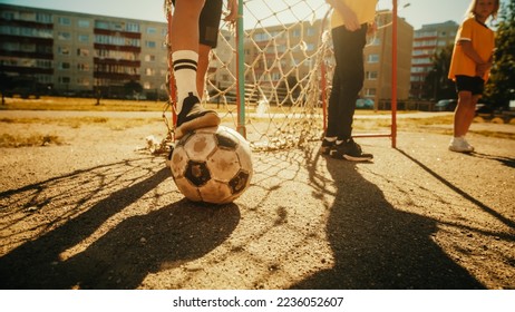 Close Up Shot : Young Boy Stopping a Ball with his Foot. Young Football Players Getting Ready to Start a Soccer Match in Neighborhood Pitch. Enjoying Childhood with Sports, Action and Friendship - Powered by Shutterstock