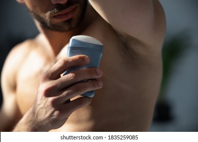 Close up shot of young handsome man with muscle body using deodorant - Powered by Shutterstock