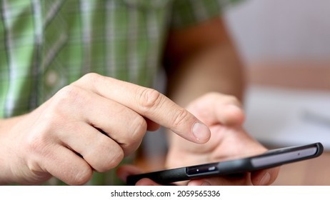 Close Up Shot Of A Young Male Scrolling And Typing On His Smart Phone