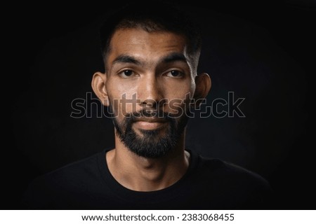 Close up shot of young men with beard and mustache in studio black background