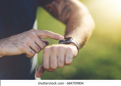 Close up shot of young sportsman using smartwatch to track him workout performance - Powered by Shutterstock