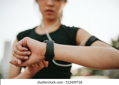 Close up shot of young sportswoman using smartwatch to track her workout performance. Fitness female monitoring her progress on smartwatch. - Powered by Shutterstock