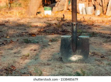 Close Up Of Shovel Head Dug Into Sand And Rock Dirt At Ceremonial Ground Breaking Event For Commercial And Residential Building Development.