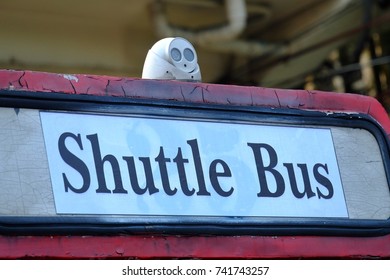 Close Up Of A Shuttle Bus Sign On The Back Of Old Public Bus With Headlight On The Roof