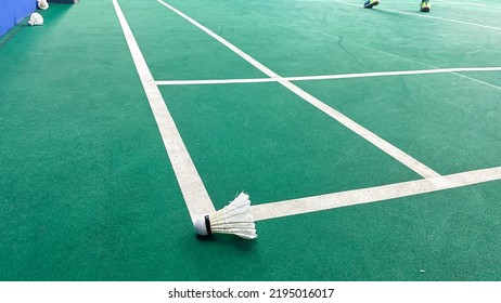 Close Up Of The Shuttlecock Above The Green Badminton Court Line. The Shuttlecock Hit The Line Means The Opposite Team Get Points