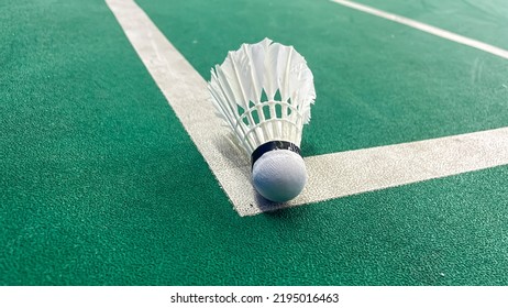 Close Up Of The Shuttlecock Above The Green Badminton Court Line. The Shuttlecock Hit The Line Means The Opposite Team Get Points