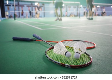 Close up shuttlecocks on racket badmintons at badminton courts with players competing
