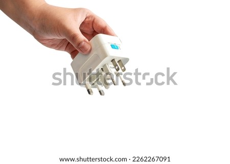 Close up sian female hand holding  Universal travel adapter plug isolated on white background and copy space with clipping path