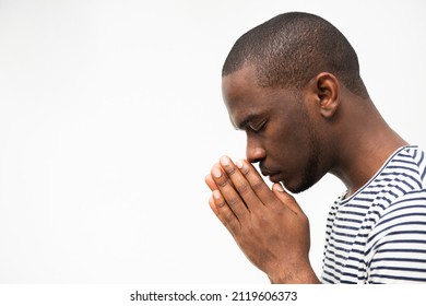 Close up side portrait african american man praying with hands clasp - Powered by Shutterstock