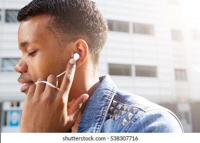 Close Up Side Portrait Of Attractive Young Man With Eyes Closed Listening To Music