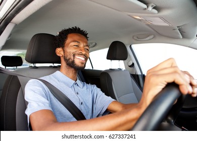 Close up side portrait of happy african american man driving car